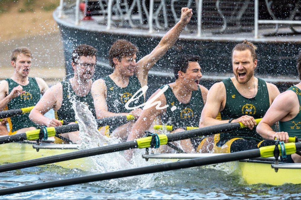 Crew celebrating a bump with a splash and a raised fist